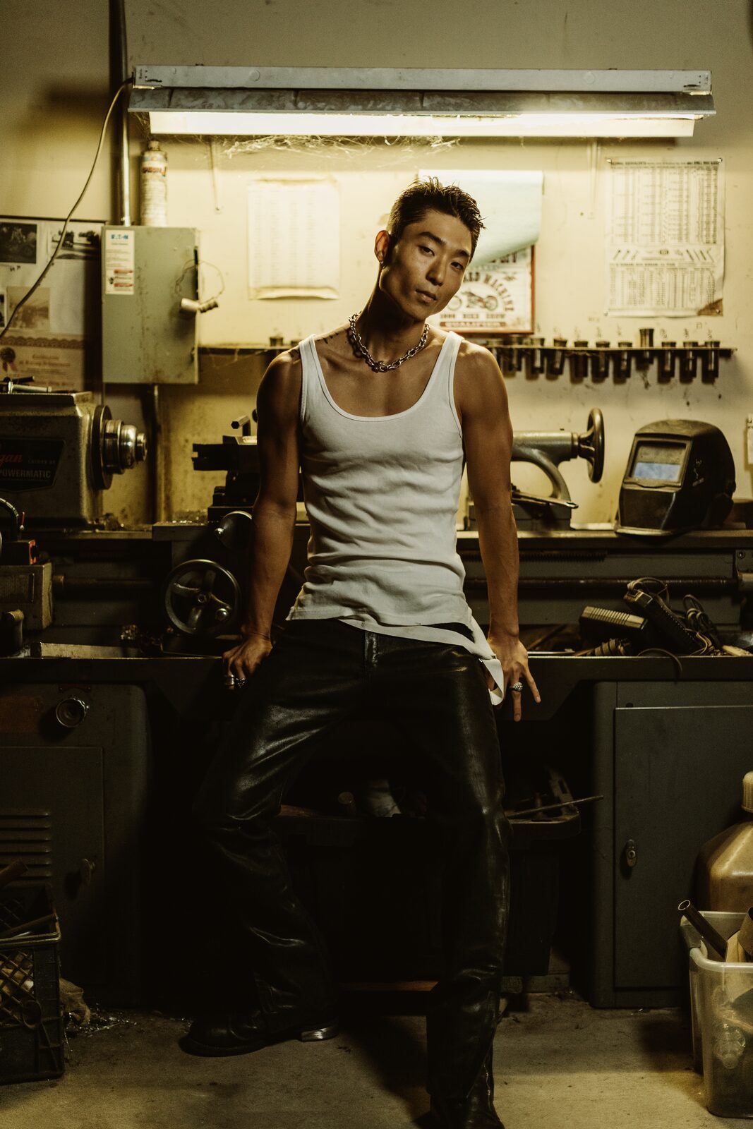 Editorial male model portrait in industrial workshop setting, by Tony Liam